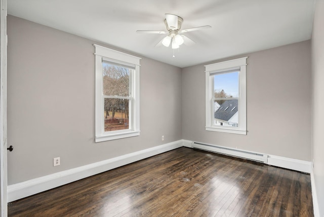 unfurnished room featuring baseboard heating, a wealth of natural light, dark wood-type flooring, and ceiling fan