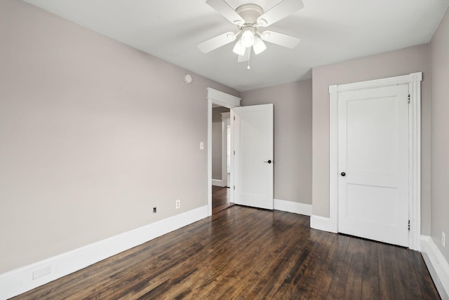 unfurnished bedroom featuring ceiling fan and dark wood-type flooring