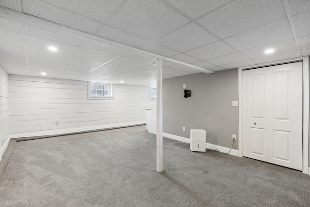 basement with carpet and a drop ceiling