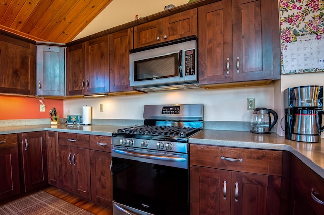 58 Wheeler Hill Rd, Phillips, ME 04966 - kitchen with stainless steel appliances, vaulted ceiling, and wood finished floors