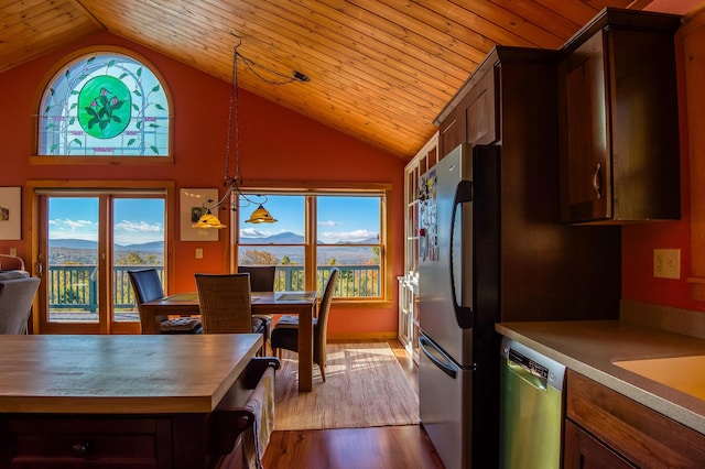 58 Wheeler Hill Rd, Phillips, ME 04966 - kitchen with stainless steel appliances, healthy amount of natural light, dark wood-style floors, vaulted ceiling, and a mountain view