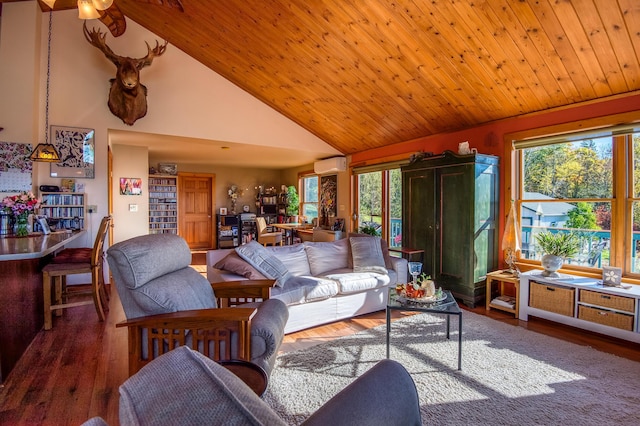 58 Wheeler Hill Rd, Phillips, ME 04966 - living area with a wall mounted AC, plenty of natural light, high vaulted ceiling, wood finished floors, and wooden ceiling