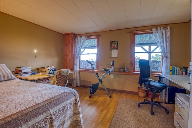 58 Wheeler Hill Rd, Phillips, ME 04966 - bedroom with a desk, light wood-type flooring, crown molding, and baseboards