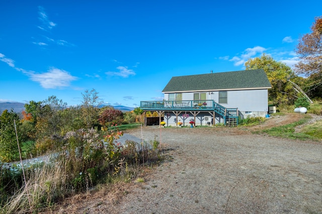 58 Wheeler Hill Rd, Phillips, ME 04966 - back of house with a deck with mountain view and stairway