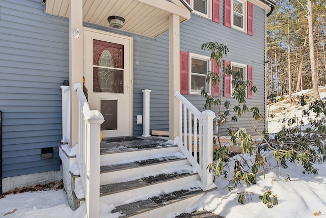 view of snow covered property entrance