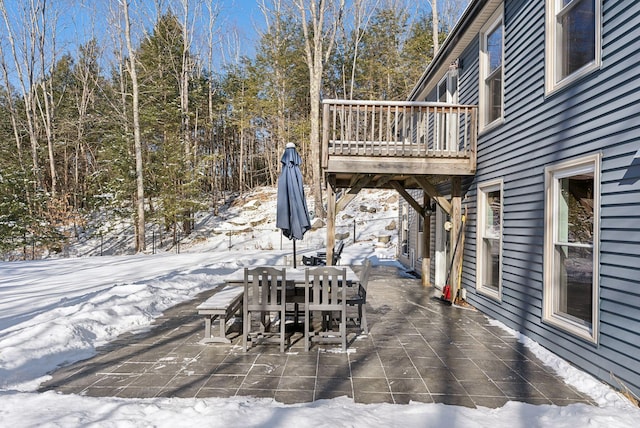 snow covered patio featuring outdoor dining area