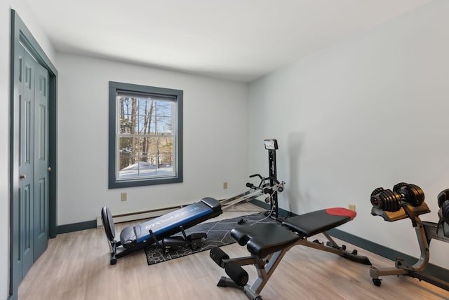 workout room featuring light wood-style floors and baseboards