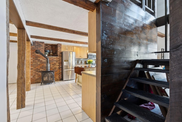 stairway featuring a wood stove, tile patterned floors, and beam ceiling