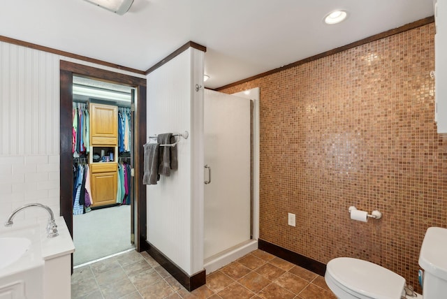 bathroom featuring a bath, a shower stall, toilet, and tile walls