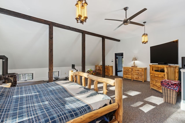 bedroom with a chandelier, vaulted ceiling, carpet, and a wood stove