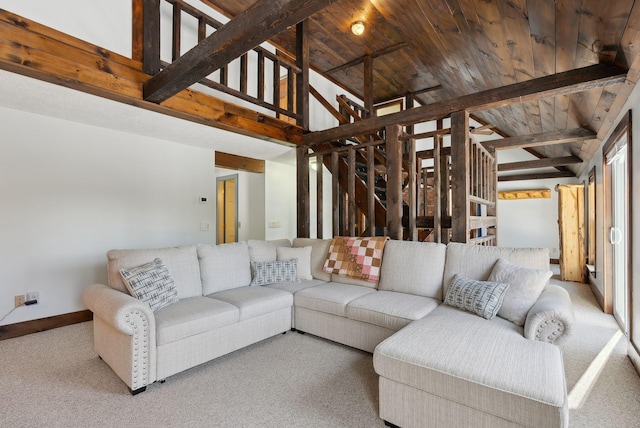 living area featuring lofted ceiling with beams, wooden ceiling, carpet, and stairway