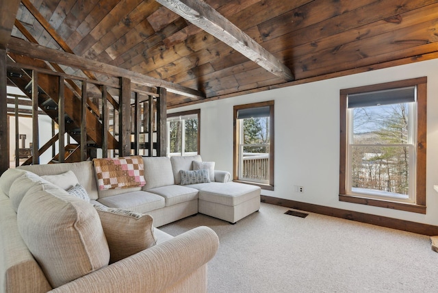 living room with vaulted ceiling with beams, visible vents, baseboards, wooden ceiling, and carpet floors