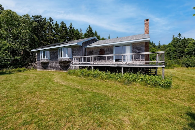 246 Marsh Stream Ln, Machiasport, ME 04655 - back of property featuring a wooden deck, a lawn, and a chimney