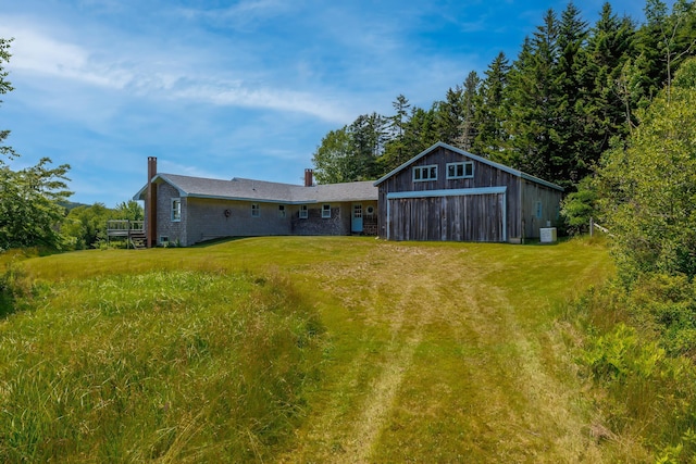 246 Marsh Stream Ln, Machiasport, ME 04655 - rear view of property with a chimney, a yard, and a garage