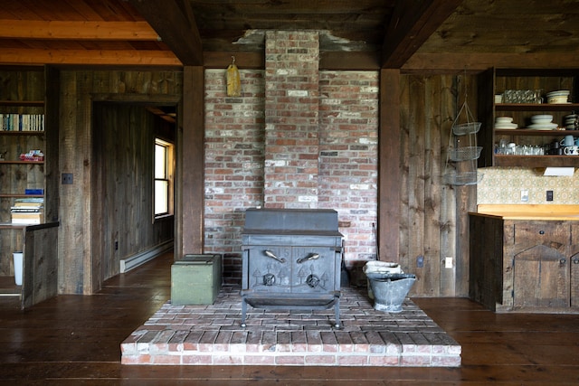 246 Marsh Stream Ln, Machiasport, ME 04655 - unfurnished living room featuring a wood stove, beam ceiling, hardwood / wood-style floors, baseboard heating, and wood walls
