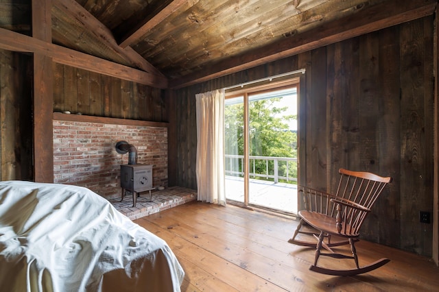 246 Marsh Stream Ln, Machiasport, ME 04655 - sitting room with a wood stove, wooden walls, wooden ceiling, and hardwood / wood-style flooring