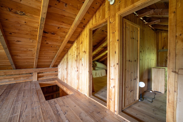 bonus room with wood walls, wooden ceiling, lofted ceiling with beams, and hardwood / wood-style floors