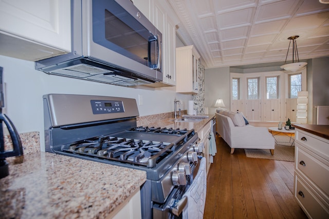 kitchen featuring appliances with stainless steel finishes, white cabinets, sink, and dark wood-type flooring