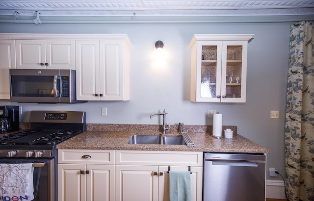 kitchen featuring sink, white cabinets, and stainless steel appliances