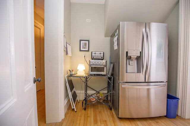 kitchen with light hardwood / wood-style floors and stainless steel refrigerator with ice dispenser