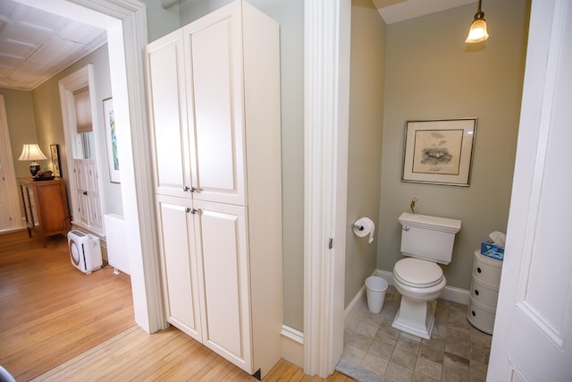 bathroom with toilet and hardwood / wood-style flooring