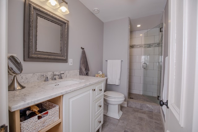 bathroom with vanity, toilet, and walk in shower