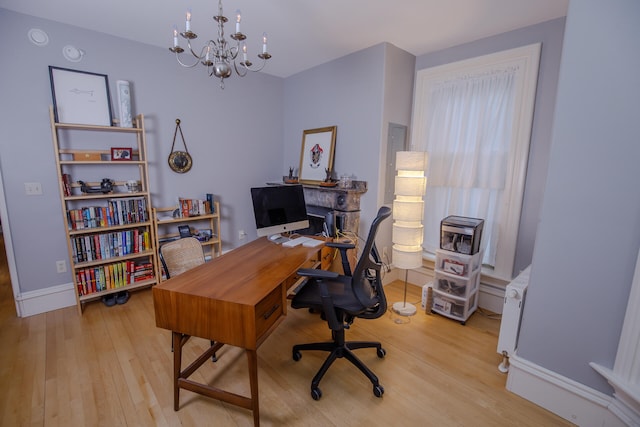 office featuring a chandelier and light wood-type flooring