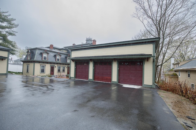 view of front facade with an outbuilding and a garage