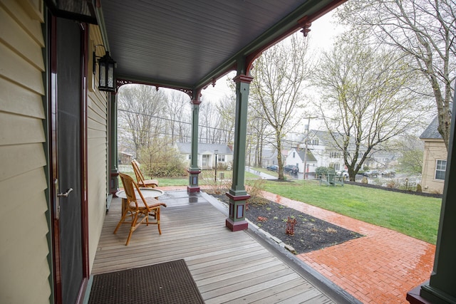 wooden terrace featuring a yard