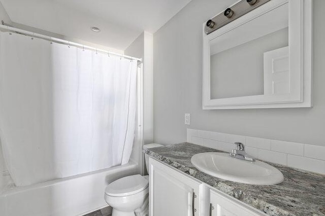 full bath with shower / bath combo, vanity, and toilet