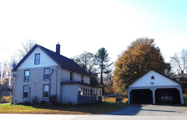 view of side of property featuring a garage and an outdoor structure