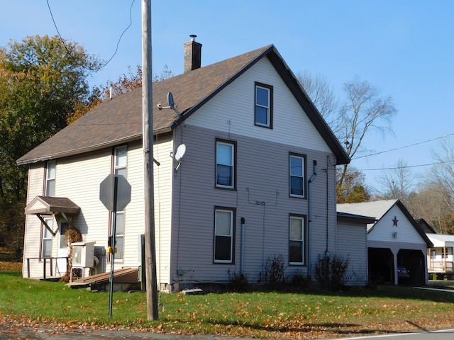 exterior space featuring a lawn and a garage