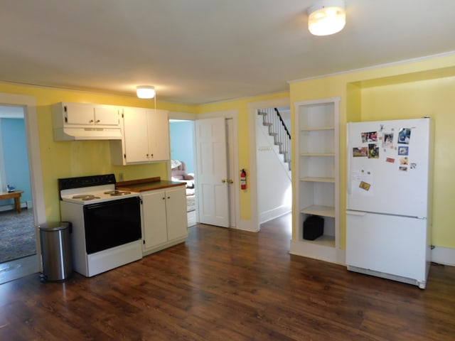 kitchen with white appliances, dark hardwood / wood-style floors, and white cabinets