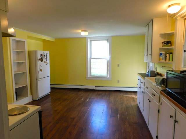 kitchen with dark wood-type flooring, white cabinetry, white fridge, and a baseboard heating unit