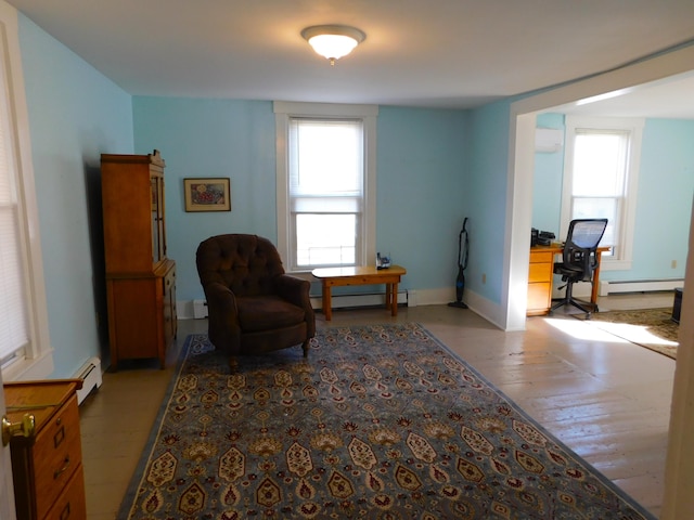 sitting room featuring a baseboard heating unit and light hardwood / wood-style flooring