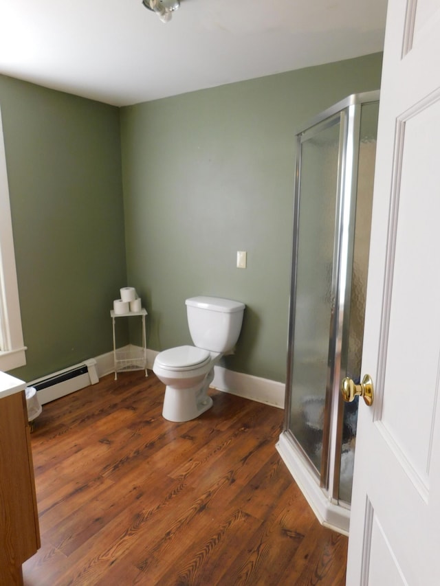 bathroom featuring hardwood / wood-style flooring, baseboard heating, toilet, and an enclosed shower