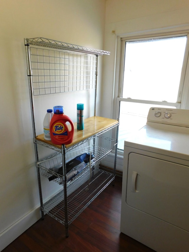 clothes washing area with dark hardwood / wood-style floors and washer / dryer