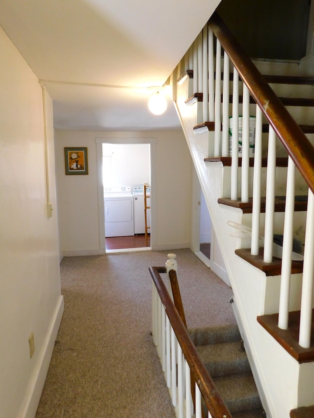 stairs featuring washer and dryer and carpet floors