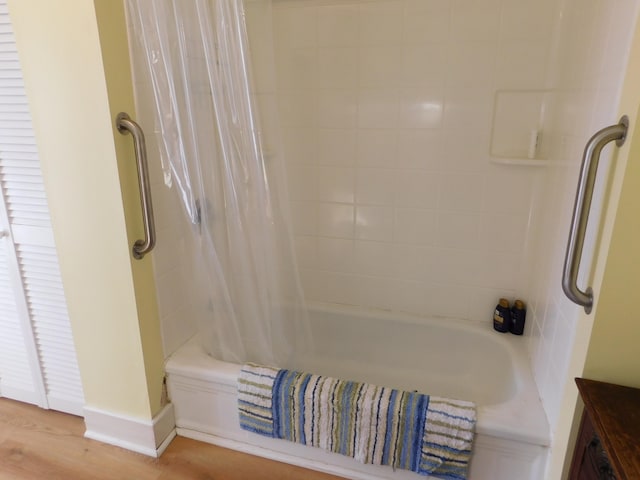 bathroom featuring shower / bath combo with shower curtain and hardwood / wood-style floors