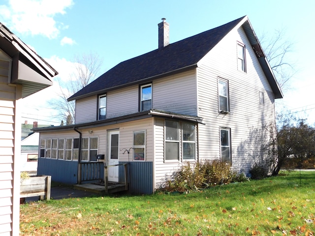 rear view of house with a lawn