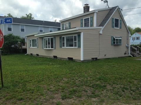 rear view of house featuring a yard