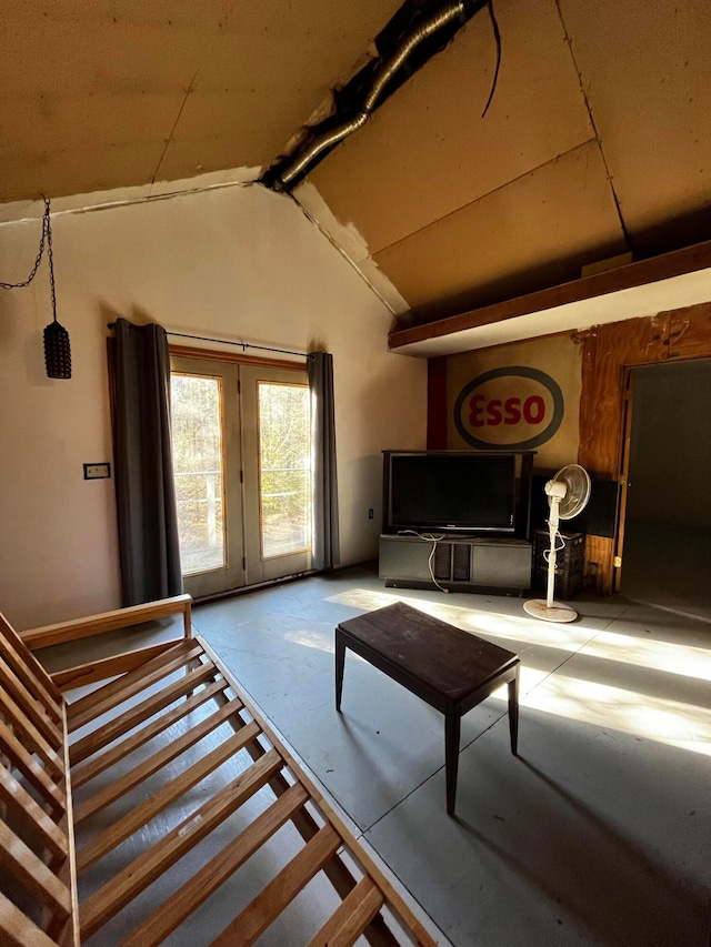 living room featuring concrete floors and lofted ceiling