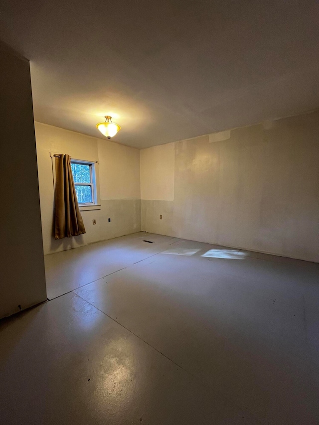 unfurnished room featuring concrete floors