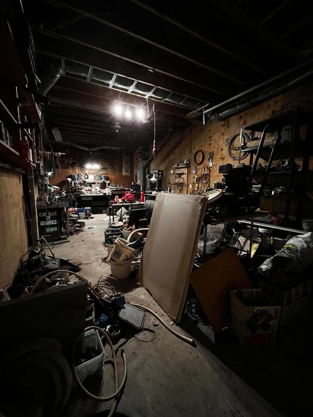 miscellaneous room with concrete floors and a workshop area