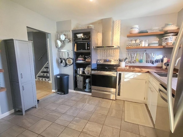 kitchen featuring stainless steel electric range oven, light tile patterned floors, open shelves, backsplash, and wall chimney range hood