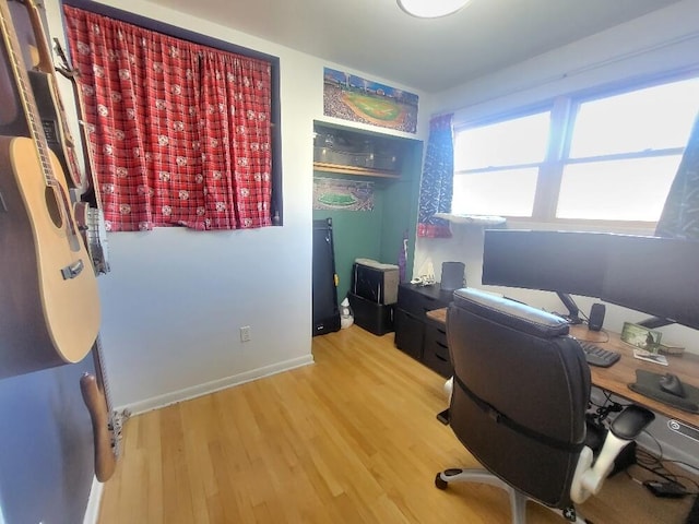 office with baseboards and light wood-style floors