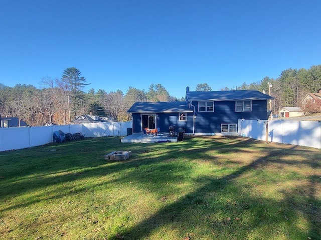 back of property featuring a patio area, a fenced backyard, and a yard