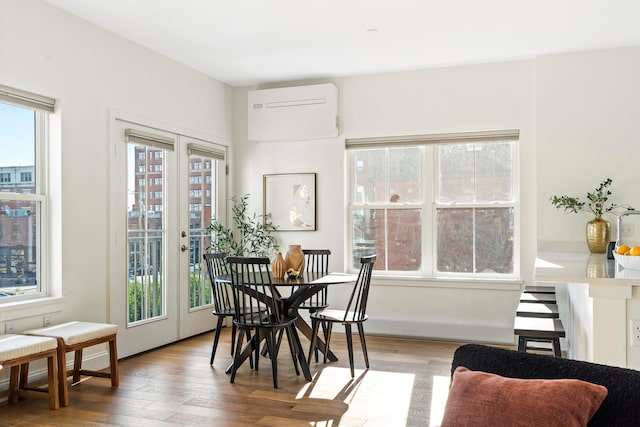 dining area featuring hardwood / wood-style flooring, a healthy amount of sunlight, and french doors