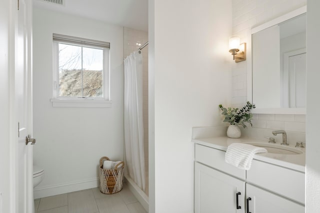 bathroom with a shower with curtain, tile patterned flooring, vanity, and toilet