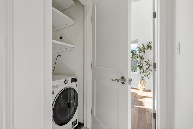 washroom with hardwood / wood-style floors and washer / clothes dryer